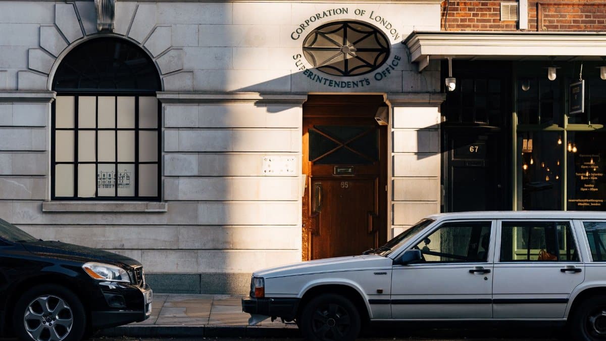 A street view of the Superintendent's Office in London with parked cars and architectural details.