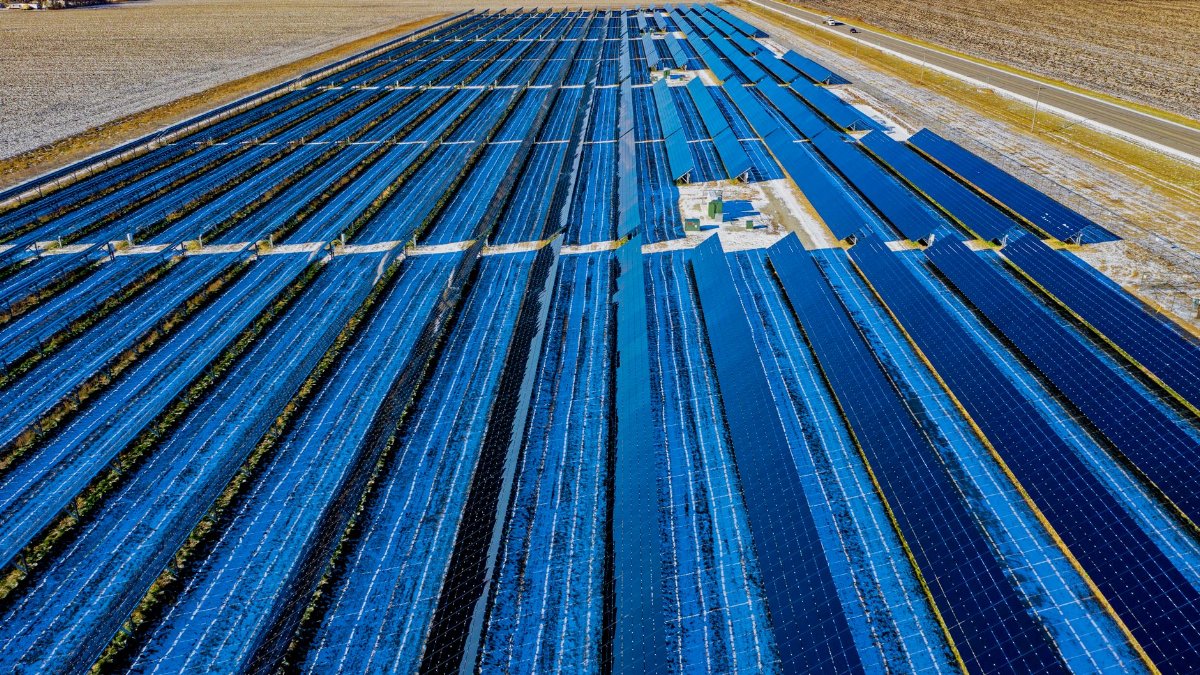 Expansive aerial view of solar panels in Claremont, MN, highlighting renewable energy.