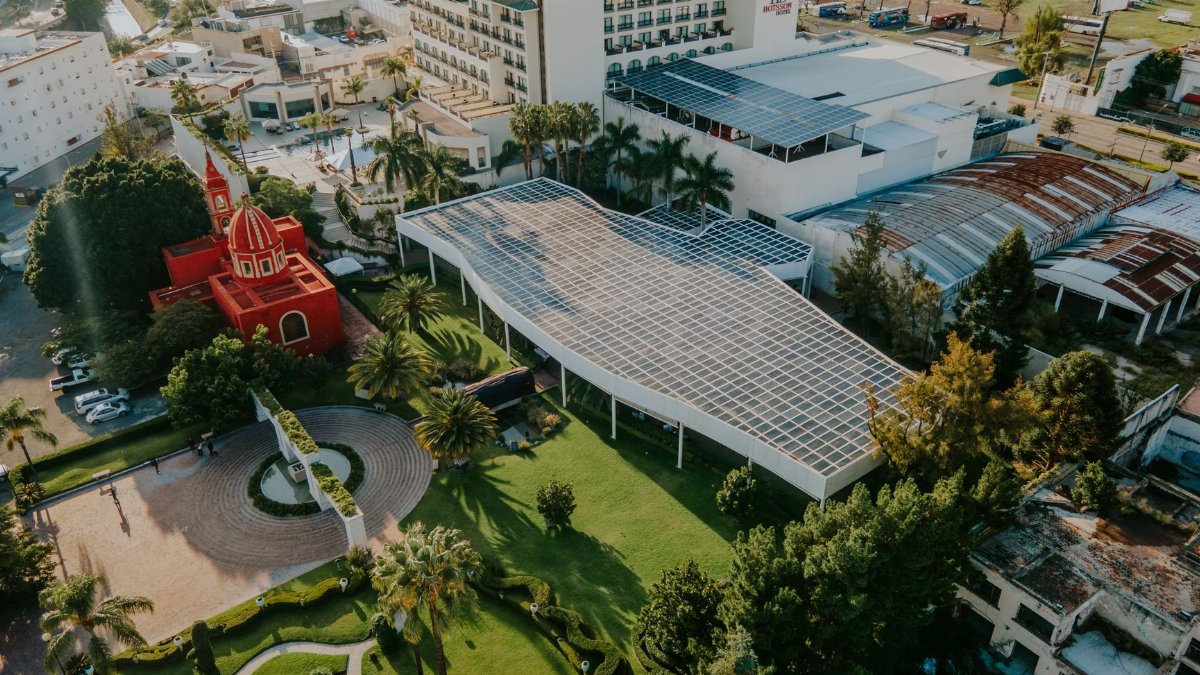 Aerial view showcasing solar panels and architectural buildings in a city setting.