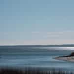 Peaceful coastal scene at Cove Island Park, Stamford with tranquil waters and clear sky.