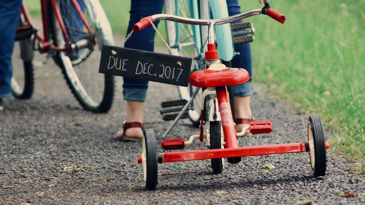 Tricycle with 'Due Dec. 2017' sign, suggesting a pregnancy announcement.
