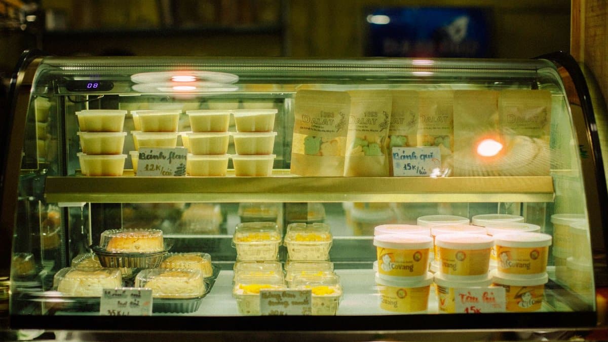 A glowing bakery display case filled with various sweet treats and packaged goods.
