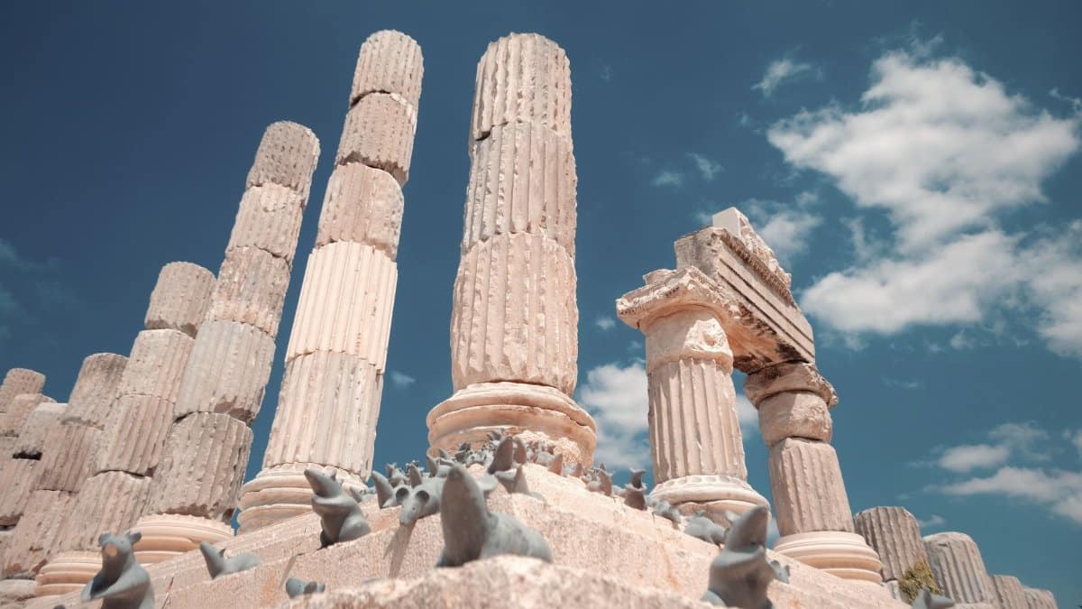 Captivating view of ancient stone columns against a bright blue sky, exuding a sense of history and timelessness.