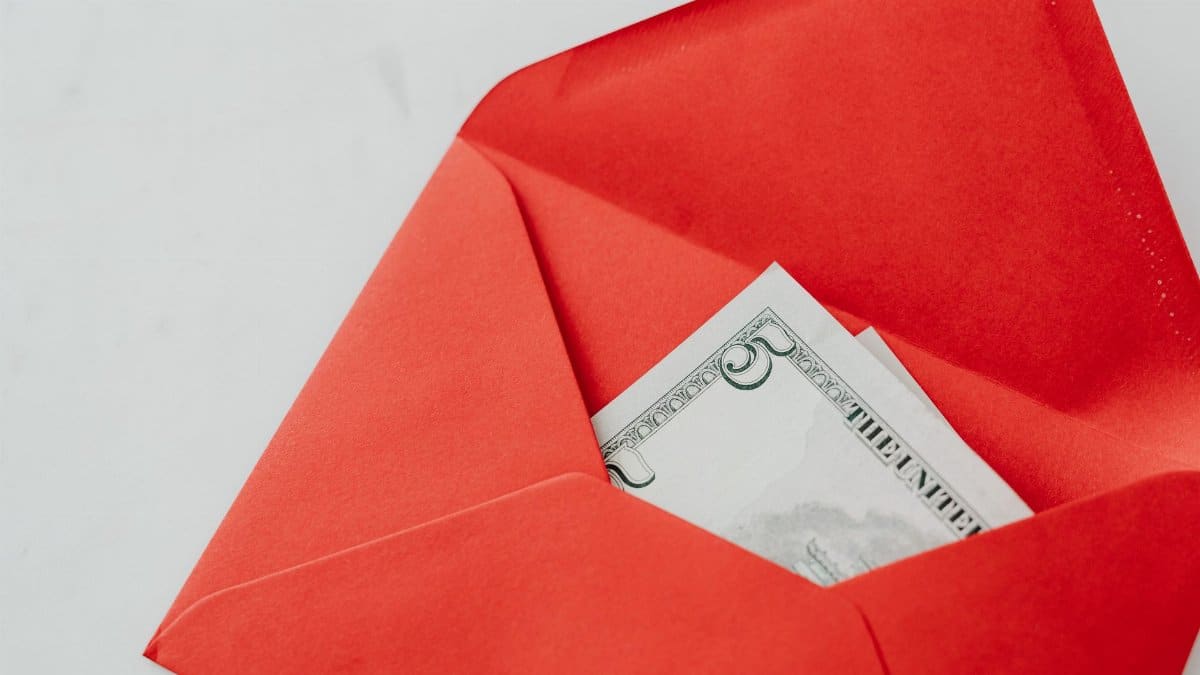 A red envelope containing a five dollar bill, perfect for gifts or special occasions.