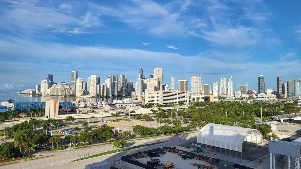 A stunning view of the Miami skyline with clear skies and bustling city life.