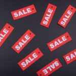 Red sale tags arranged on a dark background, ideal for retail promotions.