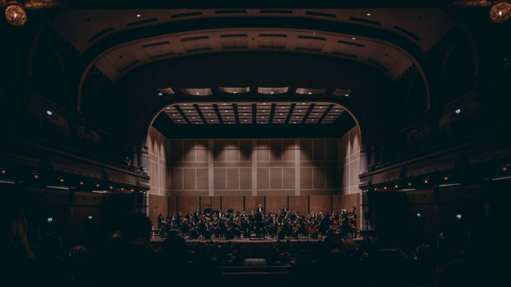Orchestra performing a symphony in a grand theater, showcasing exquisite classical music.