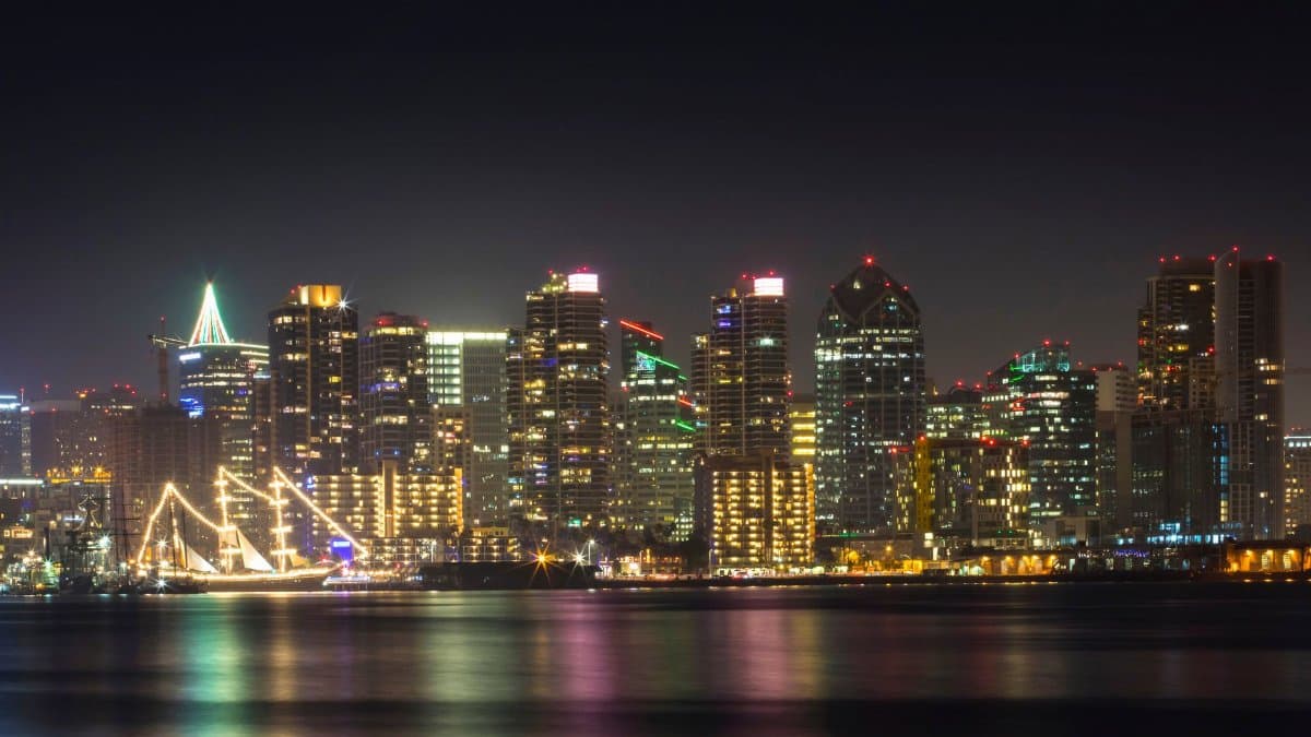 Stunning view of San Diego's illuminated skyline reflecting on the water at night.