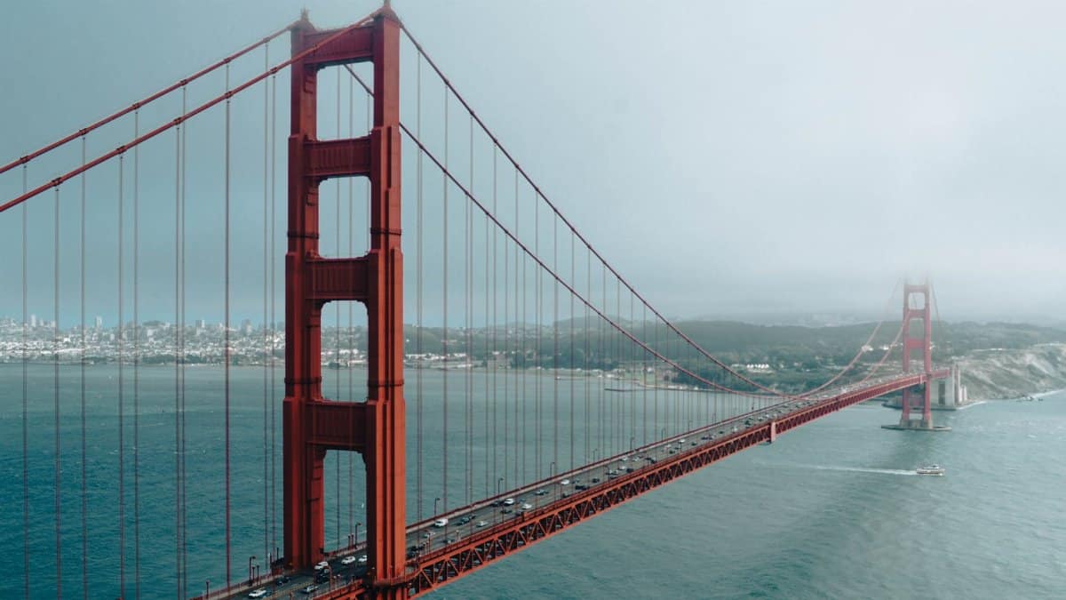 A scenic view of the Golden Gate Bridge in San Francisco enveloped in fog, showcasing its iconic architecture.