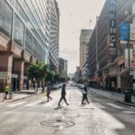Street scene in San Francisco showcasing urban architecture and diverse pedestrians crossing.