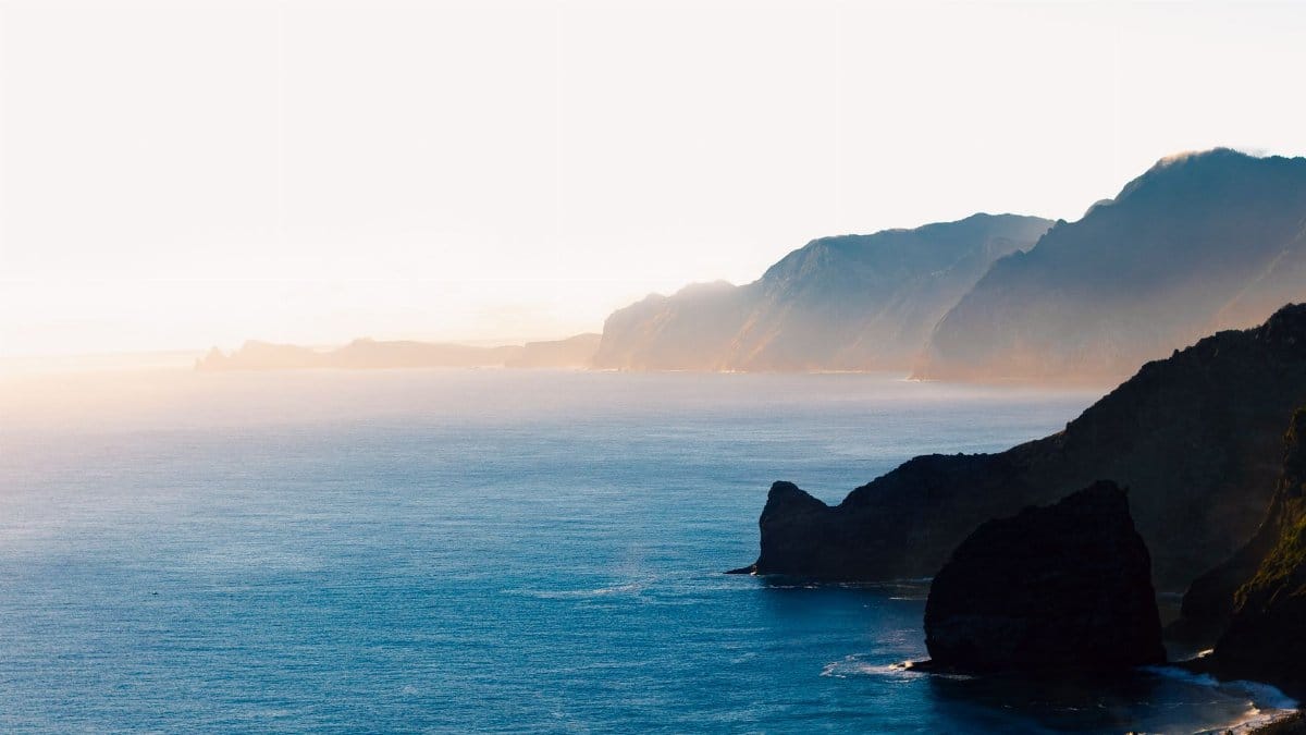 Experience the serene coastline of Santana, Madeira at sunset with stunning cliffs and ocean views.