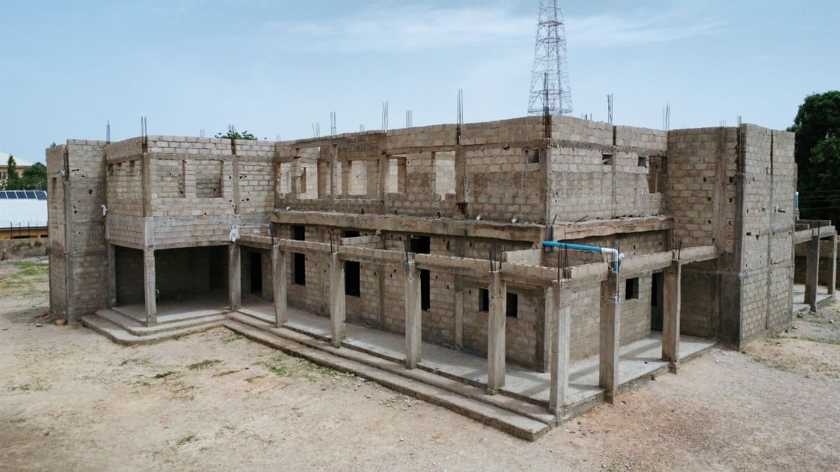 An unfinished concrete building in outdoor setting with clear sky