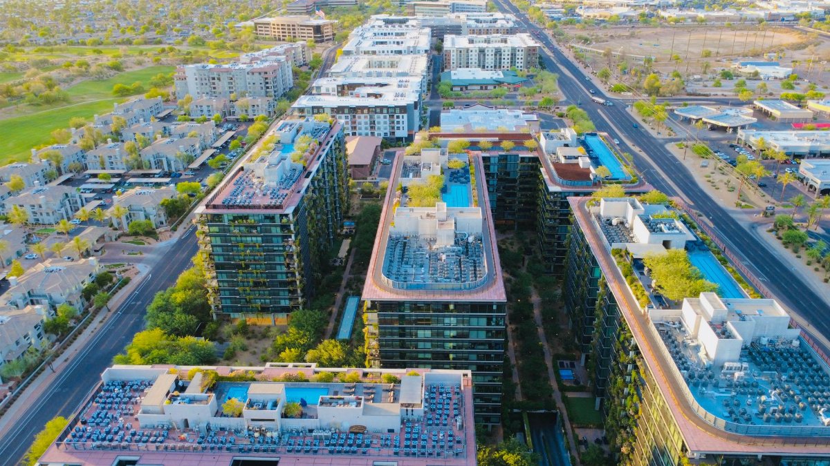 Stunning aerial view of Scottsdale, AZ, showcasing modern architecture and vibrant city life at sunset.