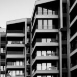 Striking black and white photo of a modern apartment building facade with geometric design.