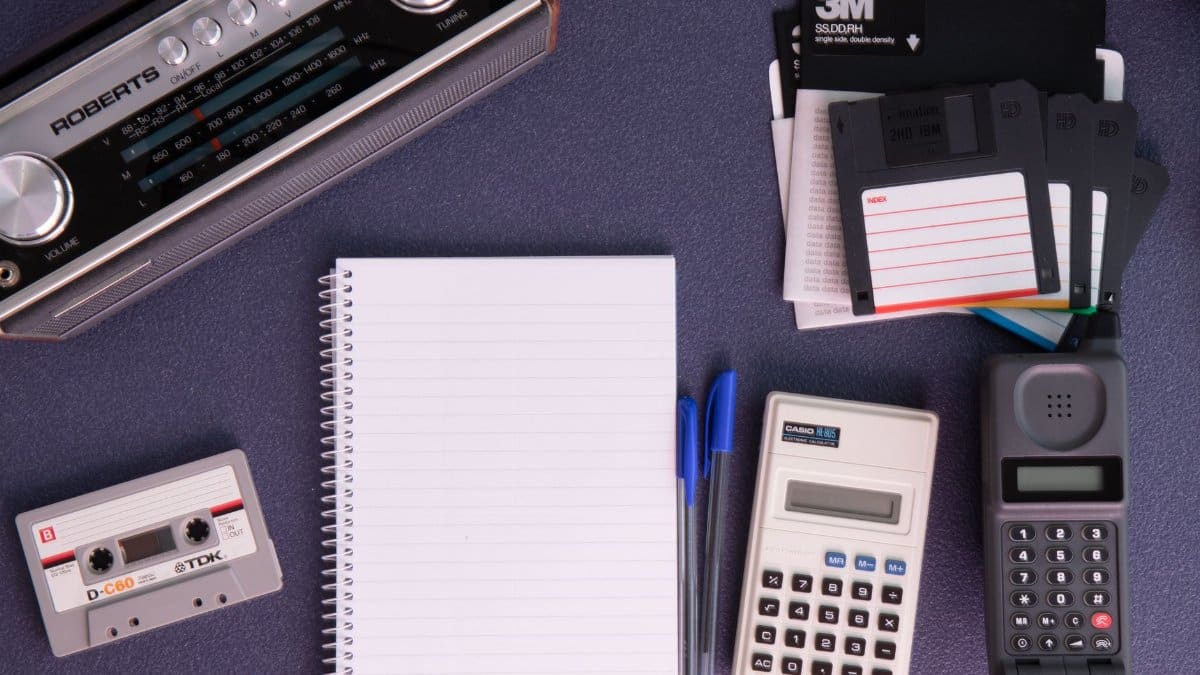 Retro flat lay featuring vintage technology and office supplies, highlighting 80s nostalgia.