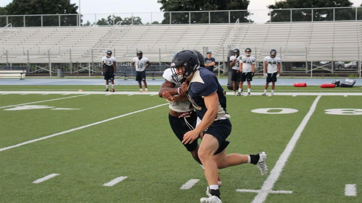 A dynamic moment captured during an American football practice on a field.