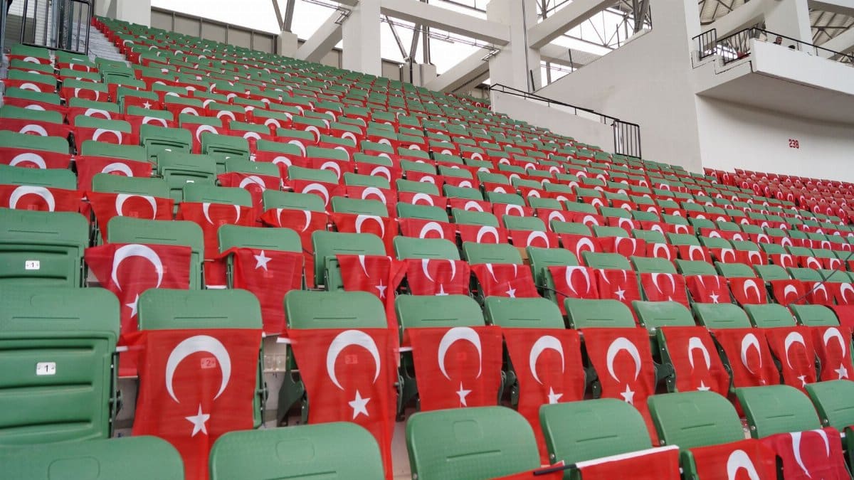 Rows of stadium seats draped with Turkish flags, symbolizing patriotism.