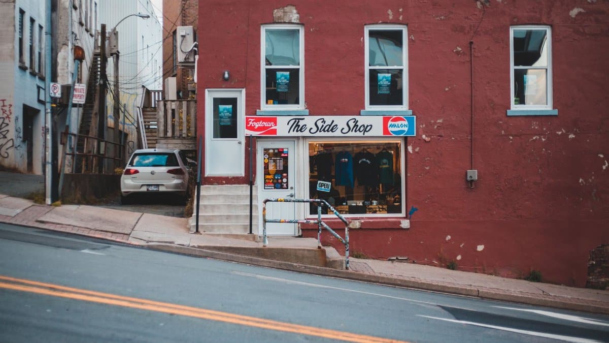 Charming city scene featuring the storefront of The Side Shop on a sloped street.