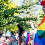 Capturing the colorful energy of a lively outdoor Pride festival with attendees celebrating diversity.