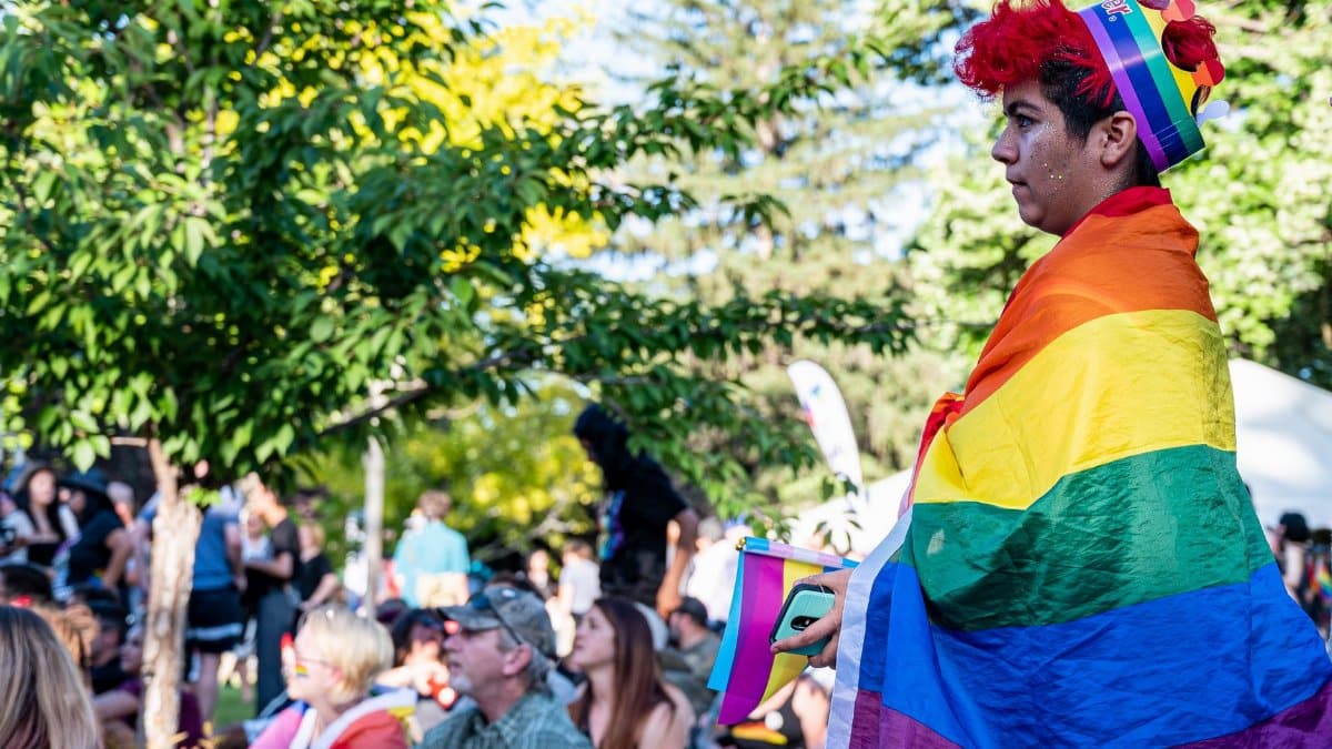 Capturing the colorful energy of a lively outdoor Pride festival with attendees celebrating diversity.
