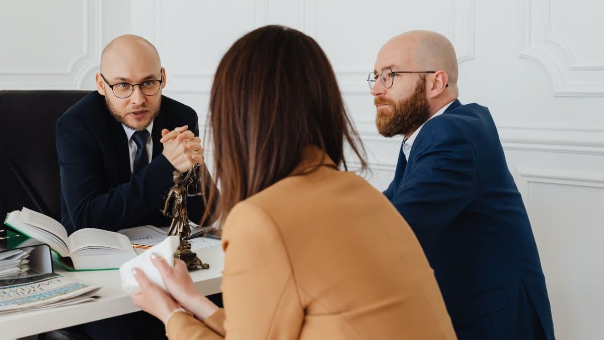 Professional discussion among lawyers in a modern office, focusing on legal matters.