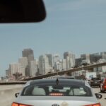 View from a car in traffic with San Francisco skyline on a clear day.