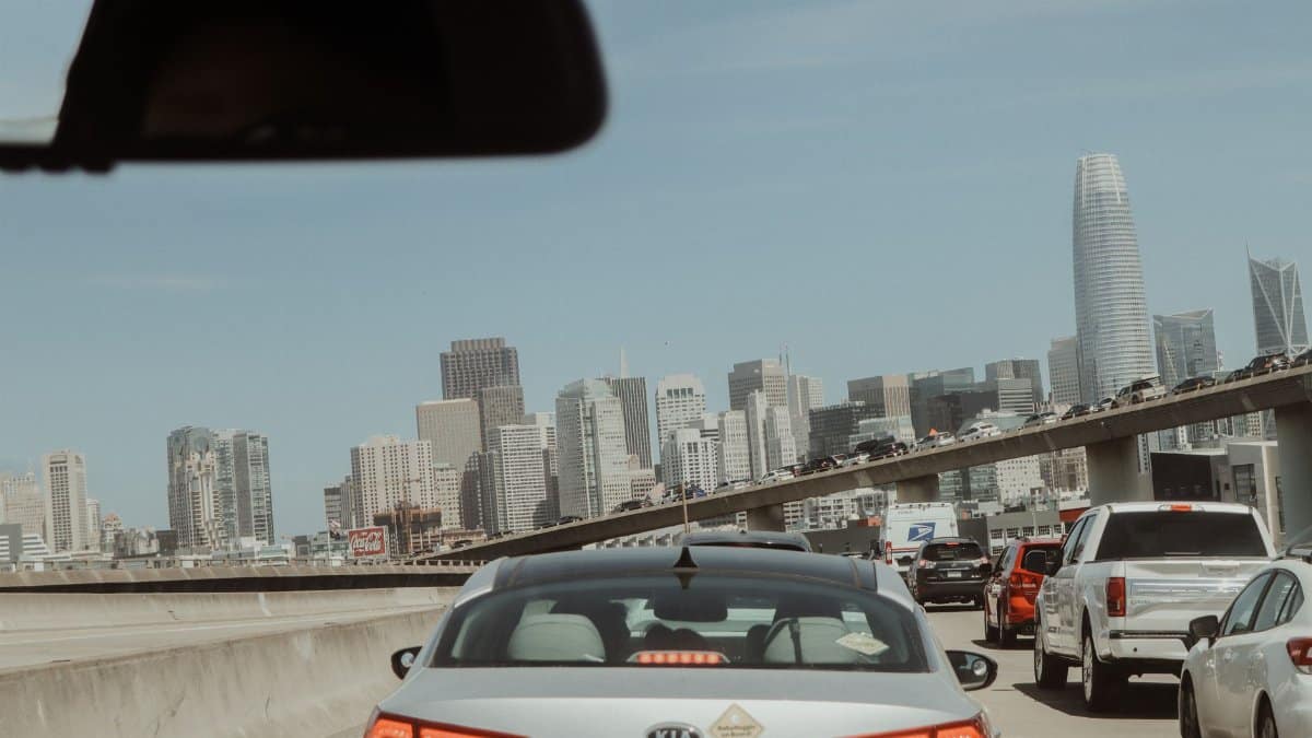 View from a car in traffic with San Francisco skyline on a clear day.