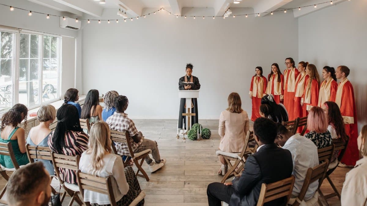 A diverse choir performs indoors under soft lighting. Spiritual atmosphere.