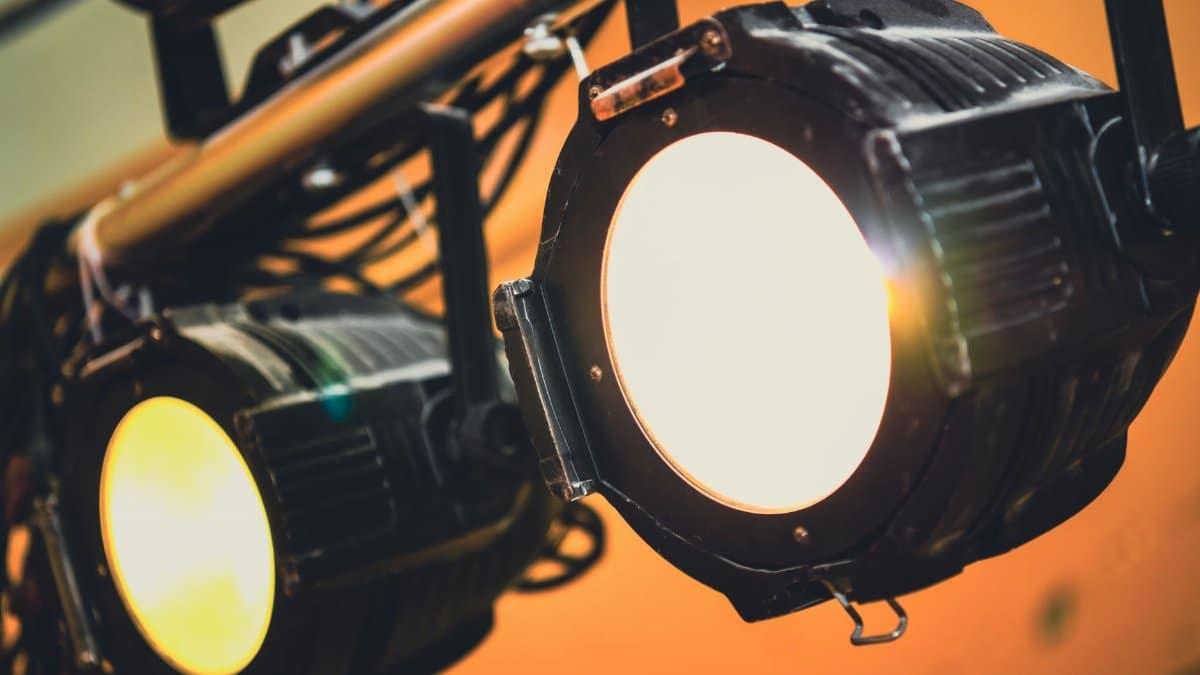 Detailed view of illuminated stage spotlights casting soft warm light