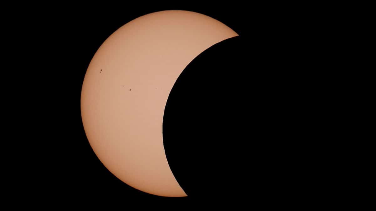 Dramatic partial solar eclipse captured over the UK, showcasing celestial beauty.