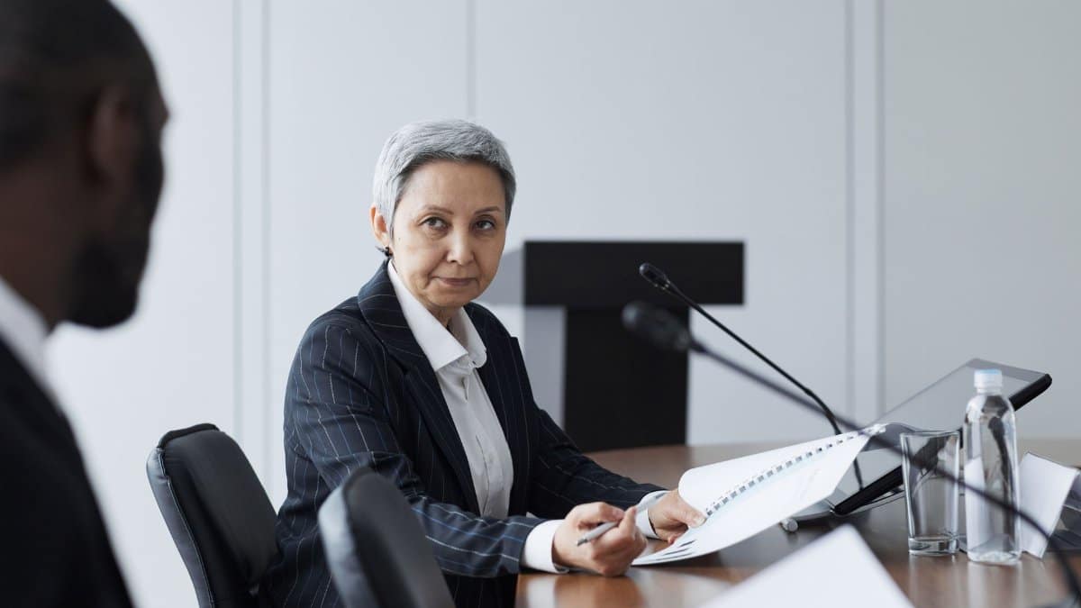 Senior businesswoman leading a conference discussion with a diverse team.