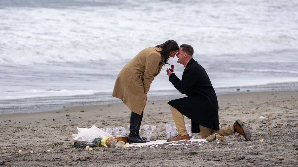 Romantic marriage proposal on a winter beach in Narragansett, Rhode Island.