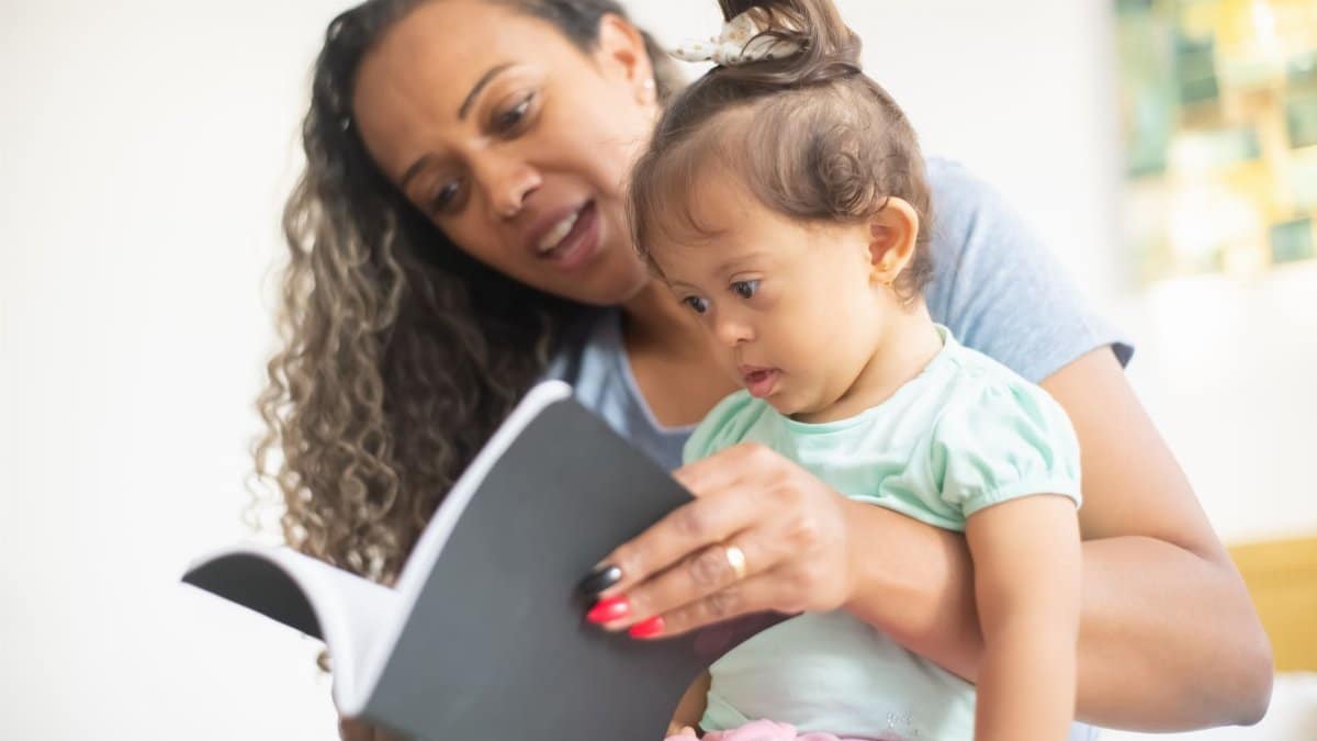 A mother and her young daughter enjoy reading a book together, fostering early learning.