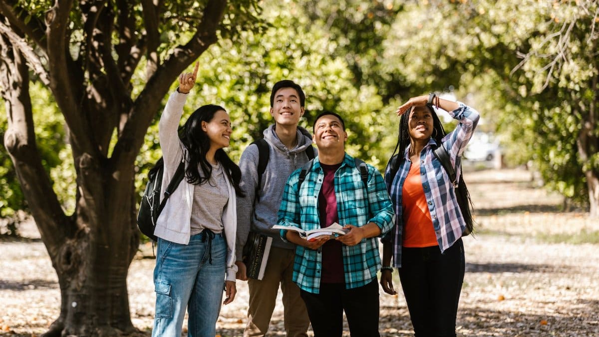 A diverse group of friends enjoying a nature walk as part of their college student life.