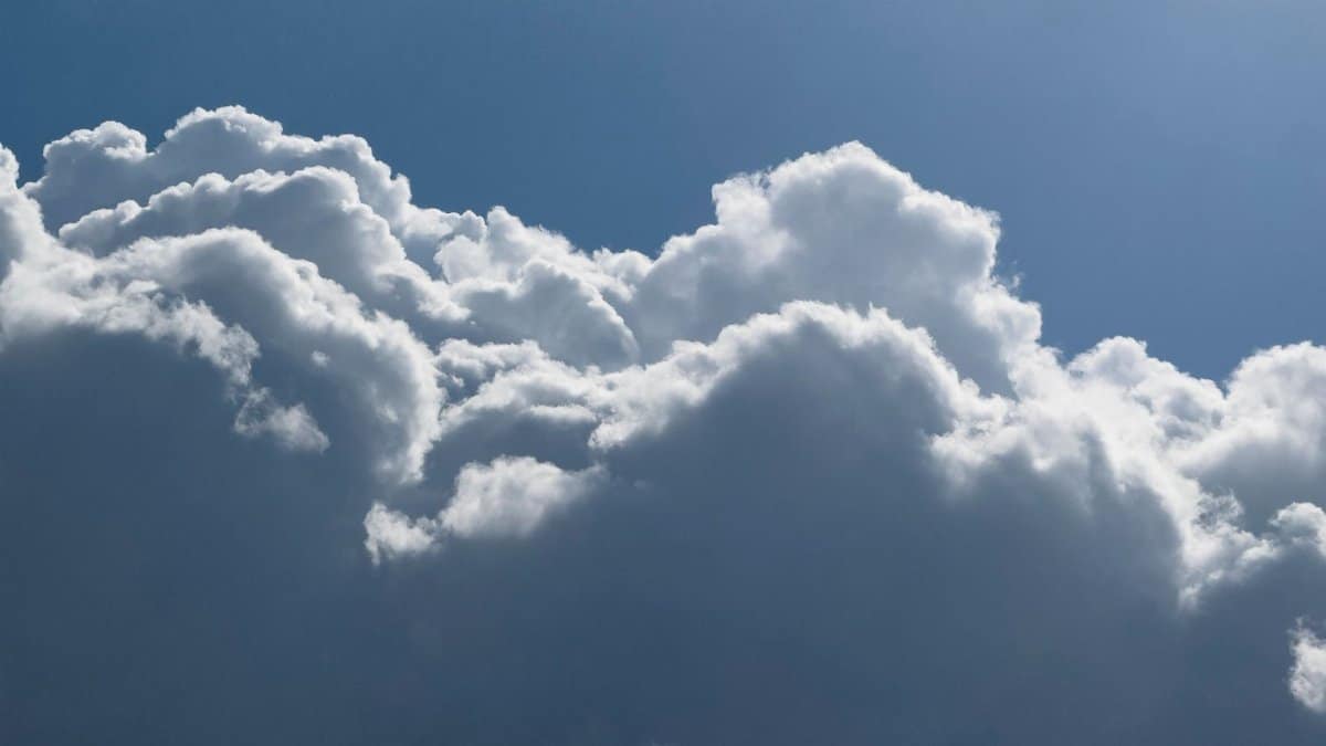 Stunning image of billowing clouds in a bright blue sky, capturing a serene summer day.