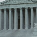 Front view of the iconic Supreme Court building with classical columns and majestic architecture.