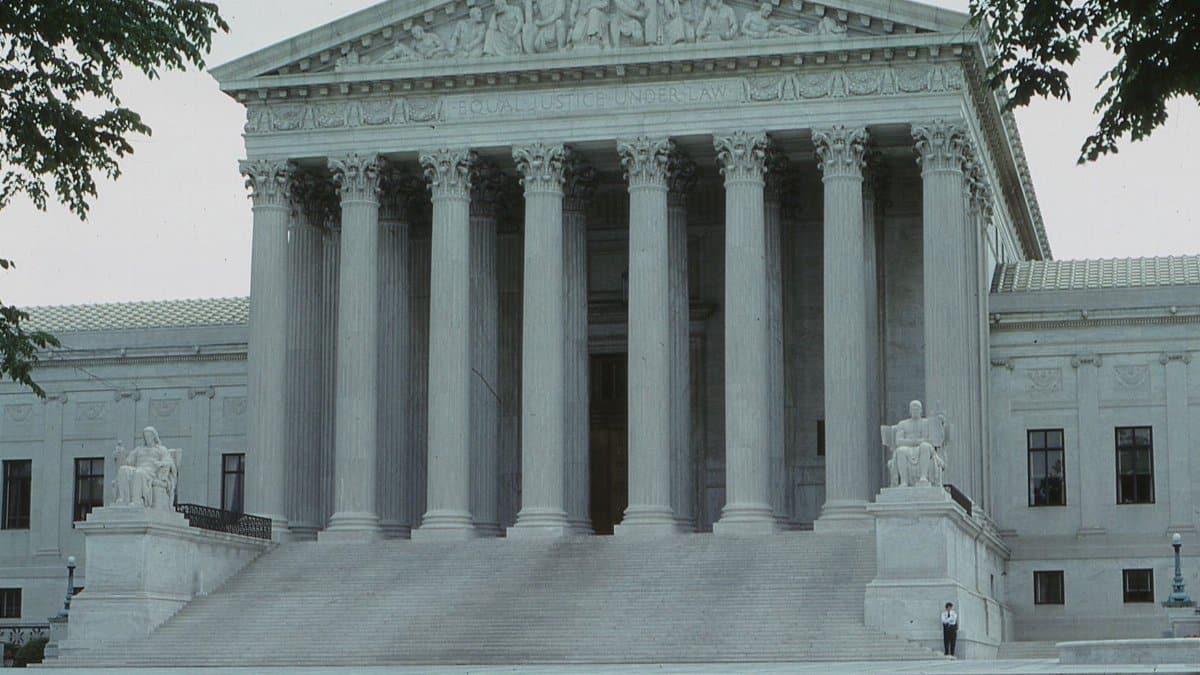 Front view of the iconic Supreme Court building with classical columns and majestic architecture.
