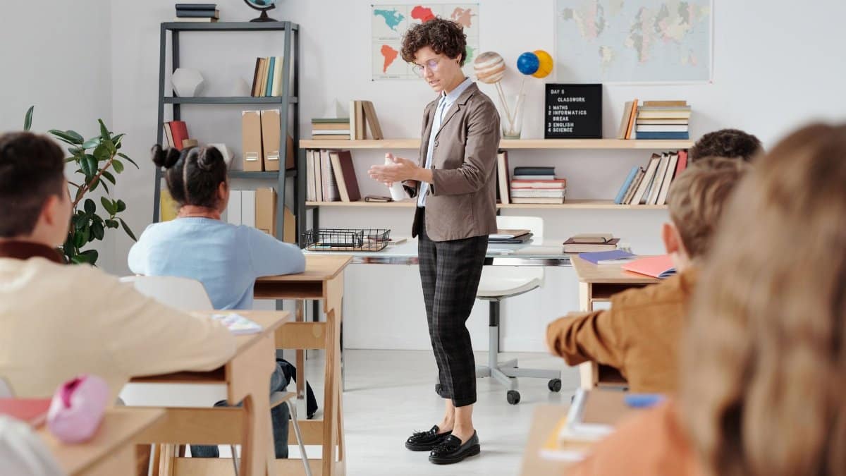 Teacher conducting a classroom lesson with attentive students in a vibrant educational setting.
