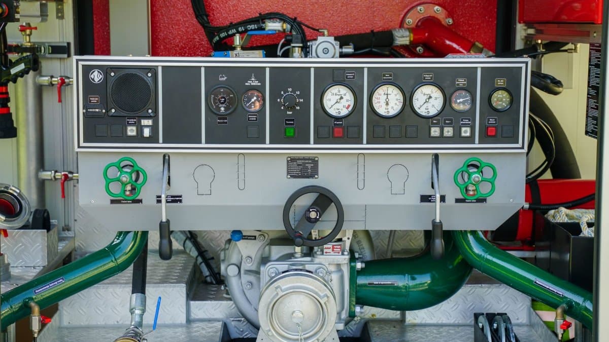 Close-up view of a fire truck dashboard with gauges and control levers.