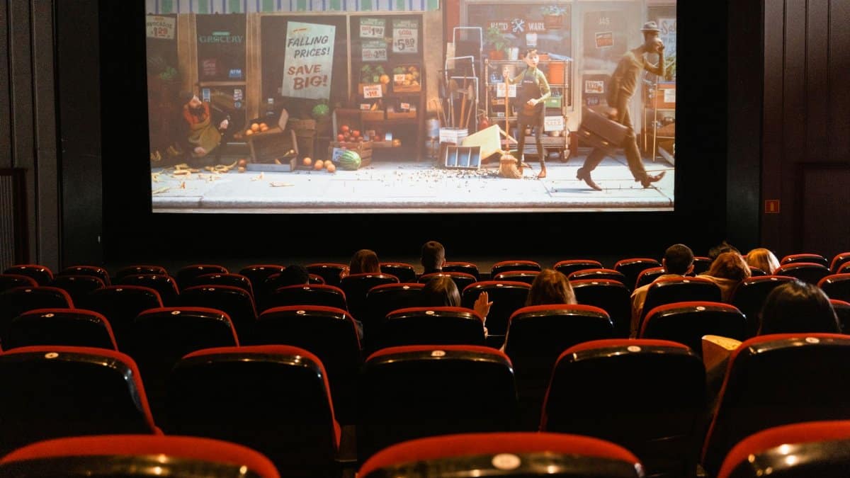 A cozy indoor movie theater showing an animated film to a small audience.
