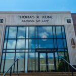 Front view of Thomas R. Kline School of Law building on a sunny day with clear sky.