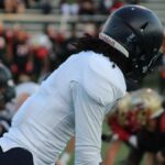 Focused shot of football players in action on a field during a game.