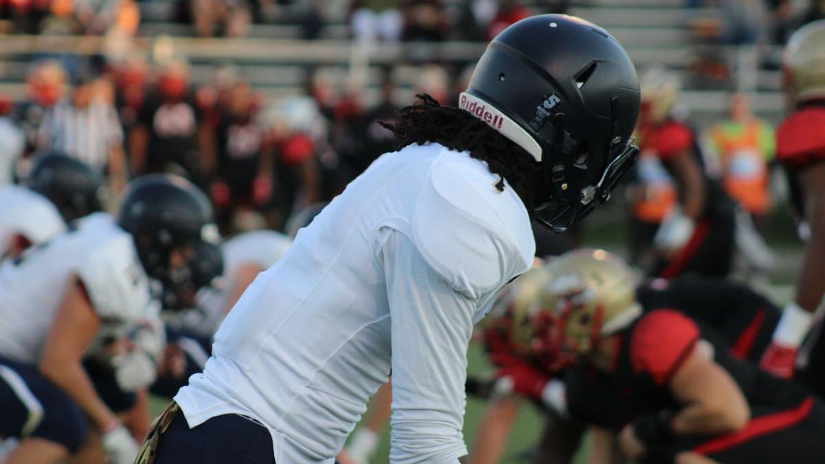Focused shot of football players in action on a field during a game.
