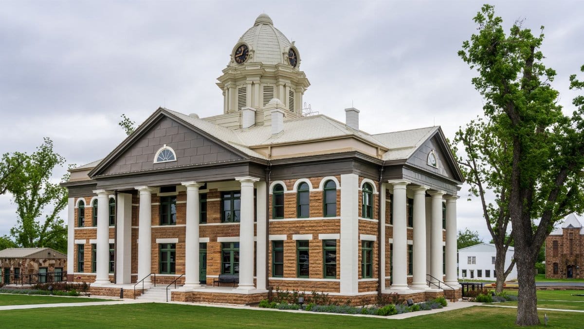 Elegant architecture of Mason County Courthouse in Texas against a cloudy sky.