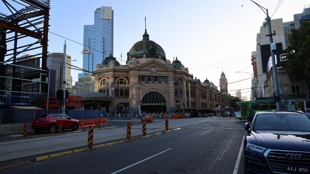 Melbourne's iconic Flinders Street Station captured in the early evening, showcasing classic architecture.