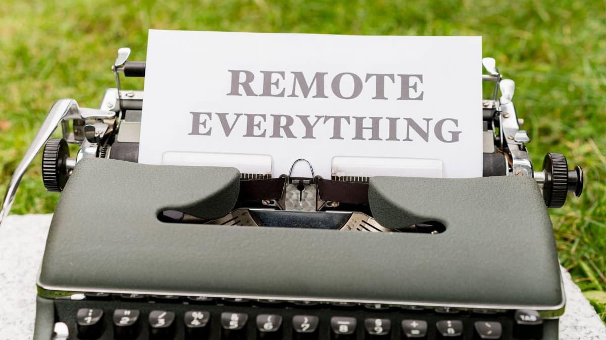 Retro typewriter displaying 'Remote Everything' in an outdoor setting, symbolizing digital transformation.