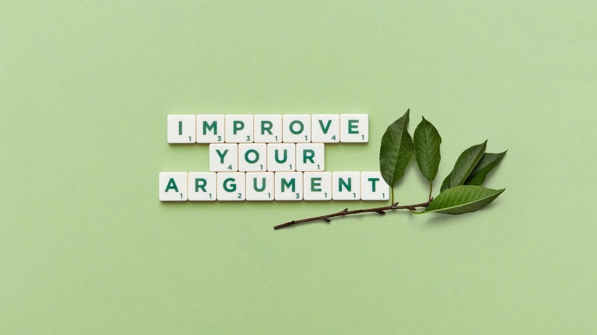 Scrabble tiles spelling 'Improve Your Argument' on a green background with leaves.