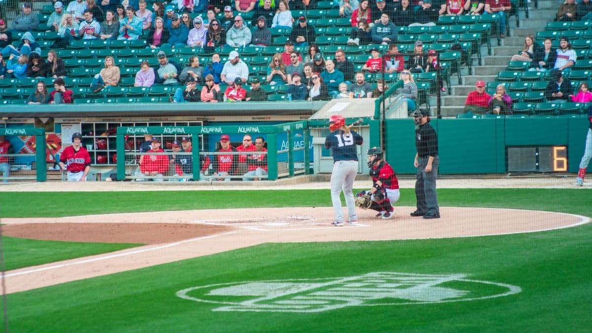 A thrilling baseball game at Victory Field, Indianapolis with players and crowd engaged.