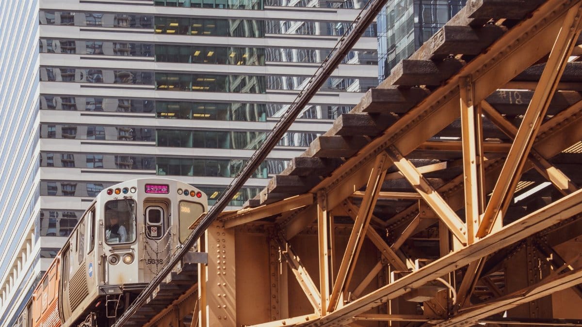 Chicago's elevated train passing through downtown with modern skyscrapers in the background.
