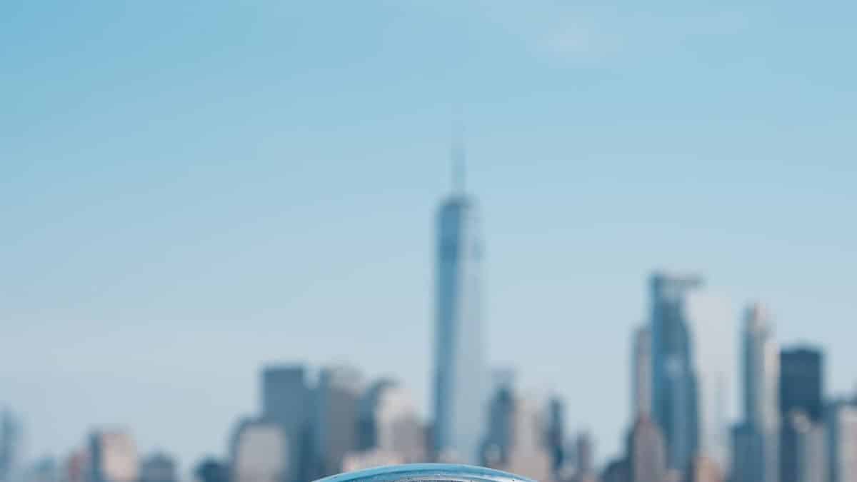 Scenic view of New York skyline with binoculars focused on One World Trade Center.